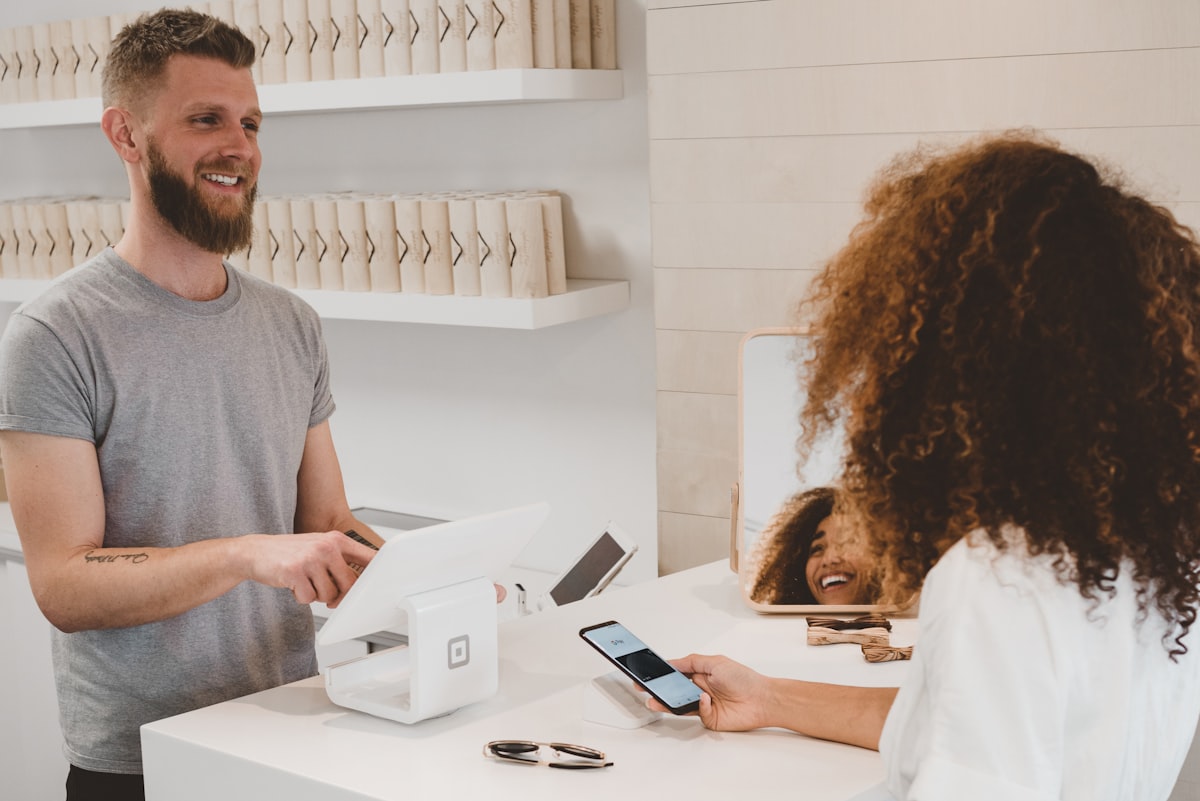 Small business owner reviewing AI website builder options on laptop in 2026